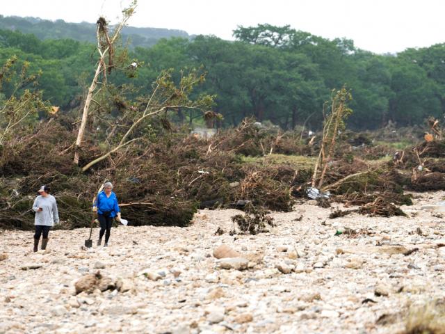 PHOTO: People search for survivors near the Guadalupe River on Sunday, July 6, 2025, in Hunt, Texas. (Jason Fochtman/Houston Chronicle via AP)