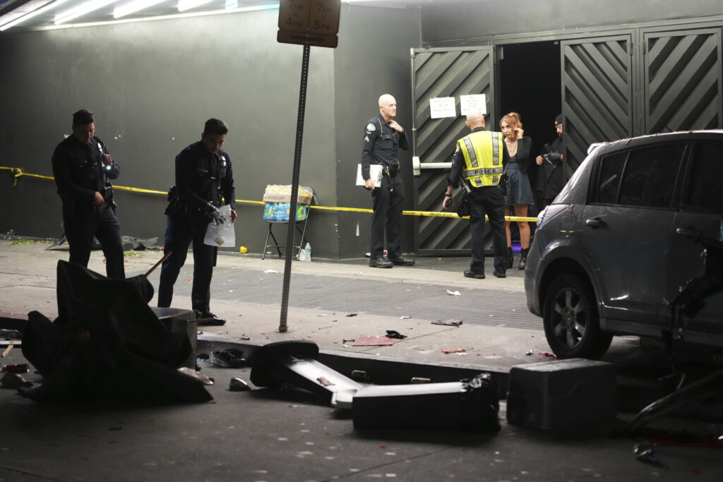 Man whose car struck crowd outside Los Angeles club, injuring 30, was shot, attacked by crowd